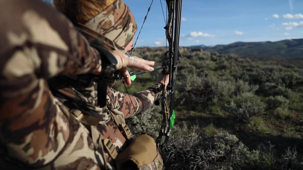 Jessi Johnson, a new hunter, takes aim with her bow and arrow